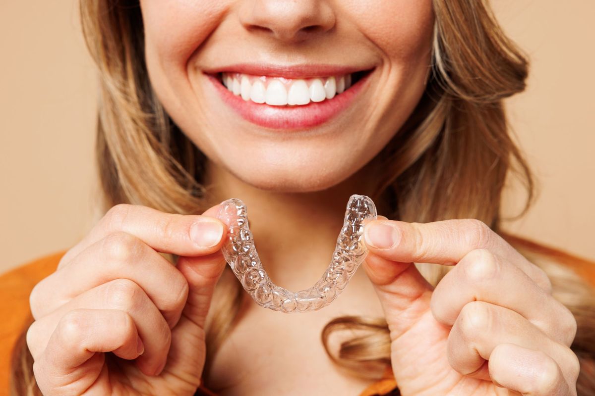 Patient holding a clear oral appliance