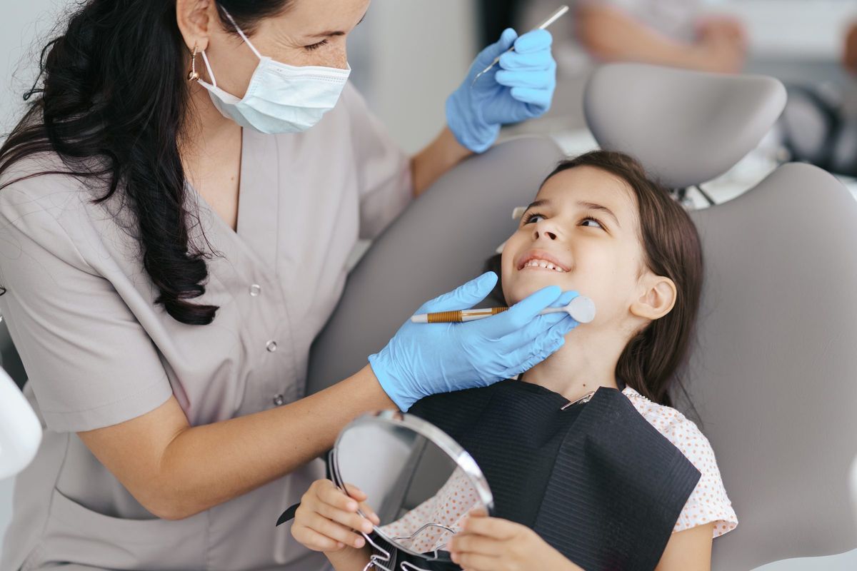 Young patient smiling at her dentist