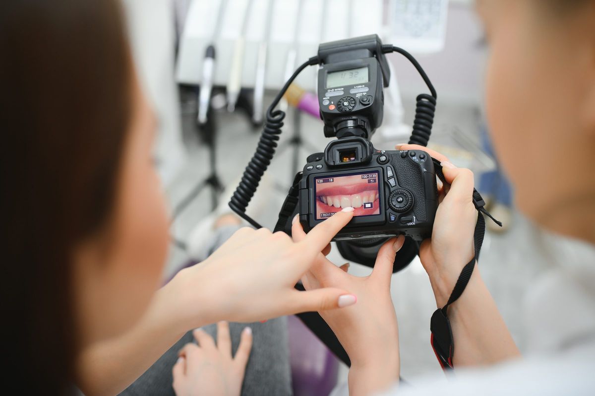 Dentist photographing a patient's smile